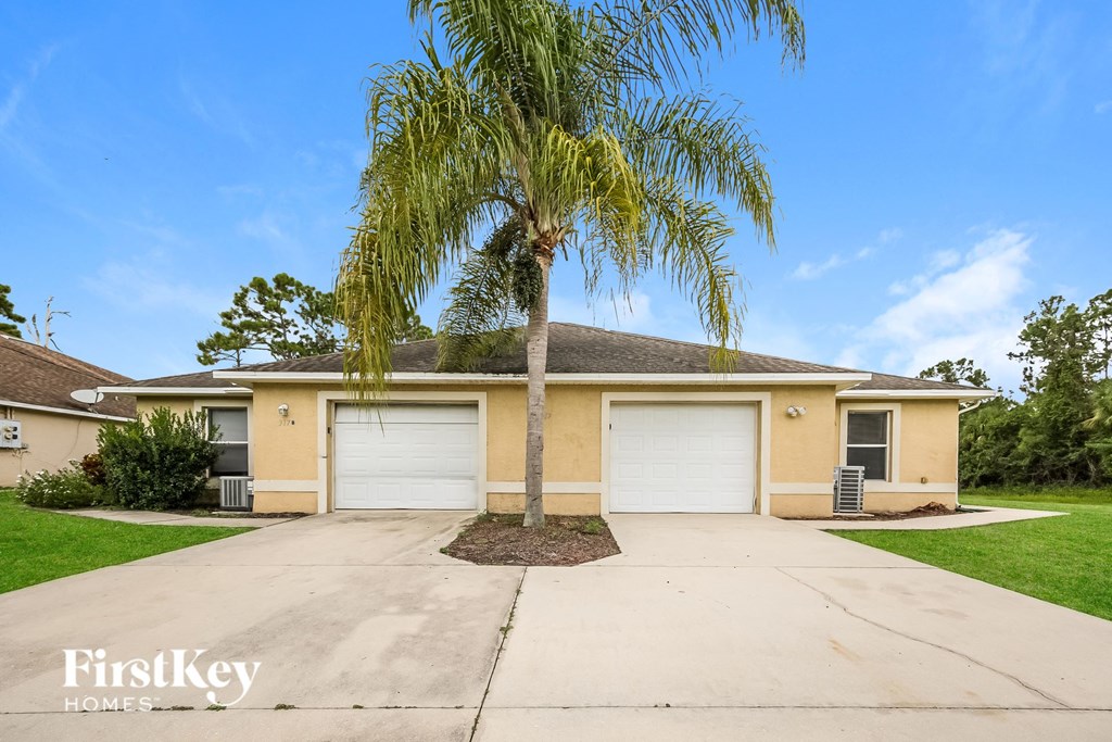 A house with a palm tree in front of it.