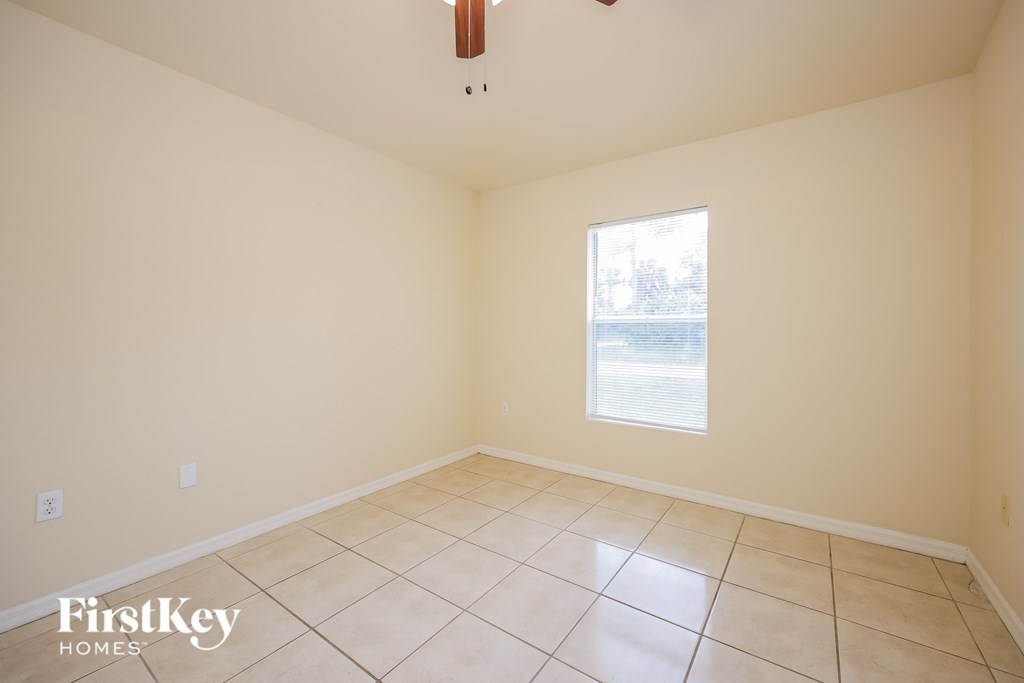 A room with a window and a tiled floor.