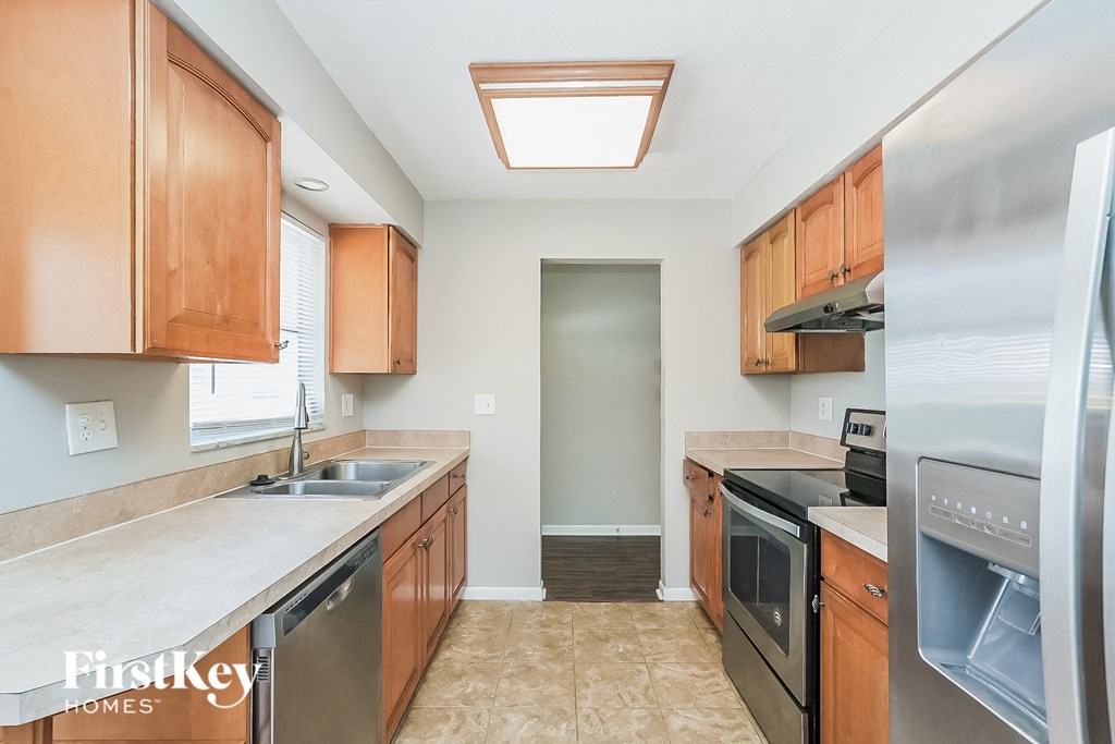 A kitchen with wooden cabinets and stainless steel appliances.