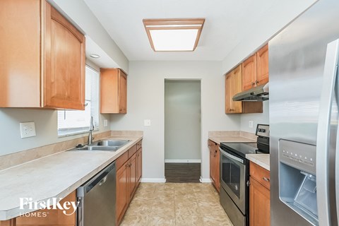 A kitchen with wooden cabinets and stainless steel appliances.