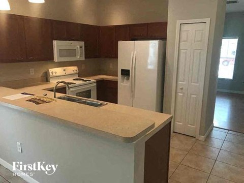 A kitchen with a white refrigerator and a counter top.