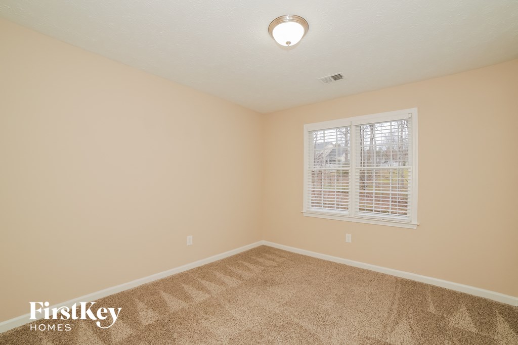 the living room of an empty house with a window