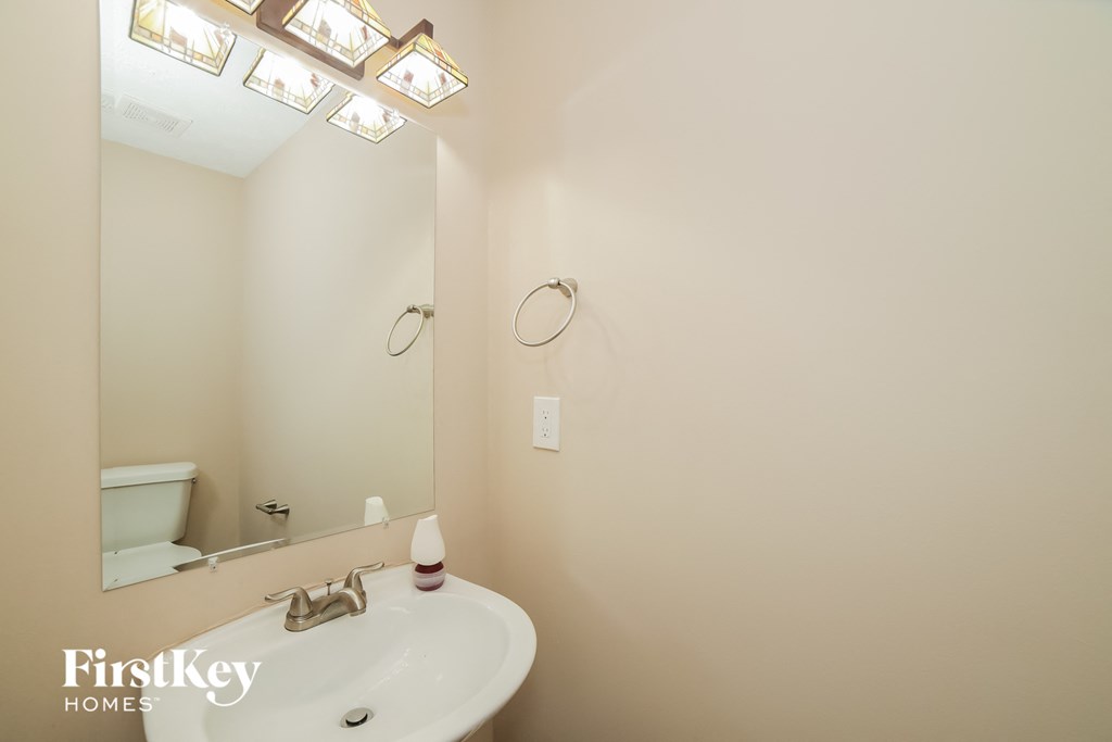 a small bathroom with a sink and a mirror