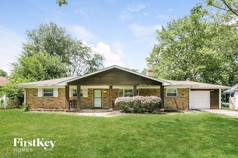 front view of a brick house with a grassy yard