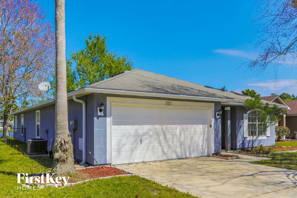 a white house with a white garage door