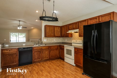 a kitchen with black appliances and wooden cabinets