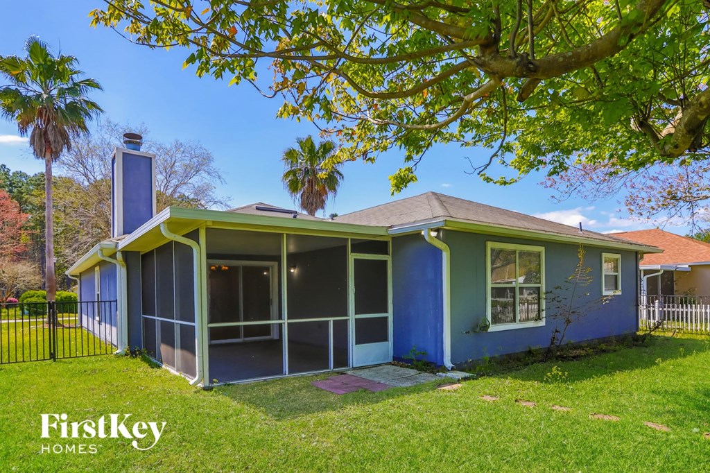 a blue house with a yard and a tree