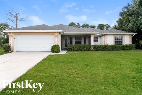 A house with a garage and a well-kept lawn.