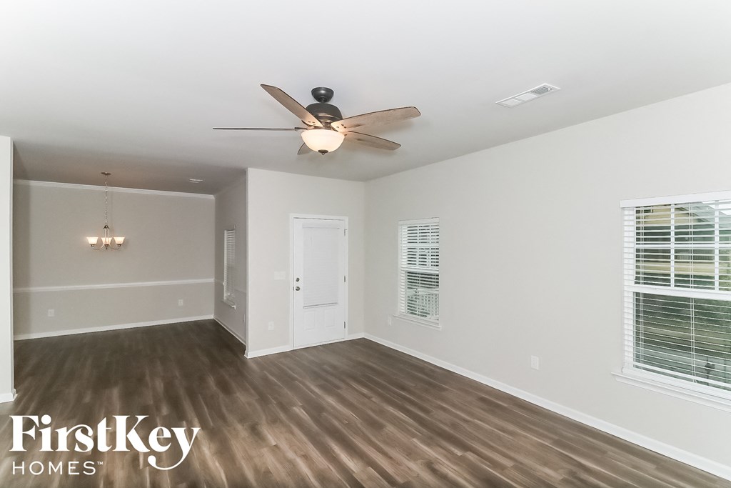 a living room with a ceiling fan and a window