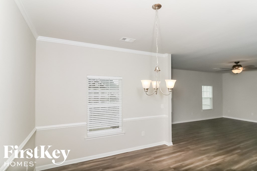 a living room with a chandelier and a window