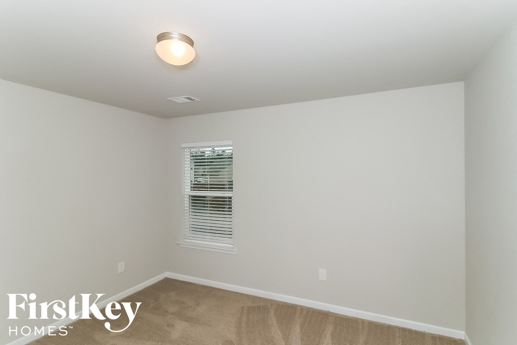 a empty room with white walls and a window