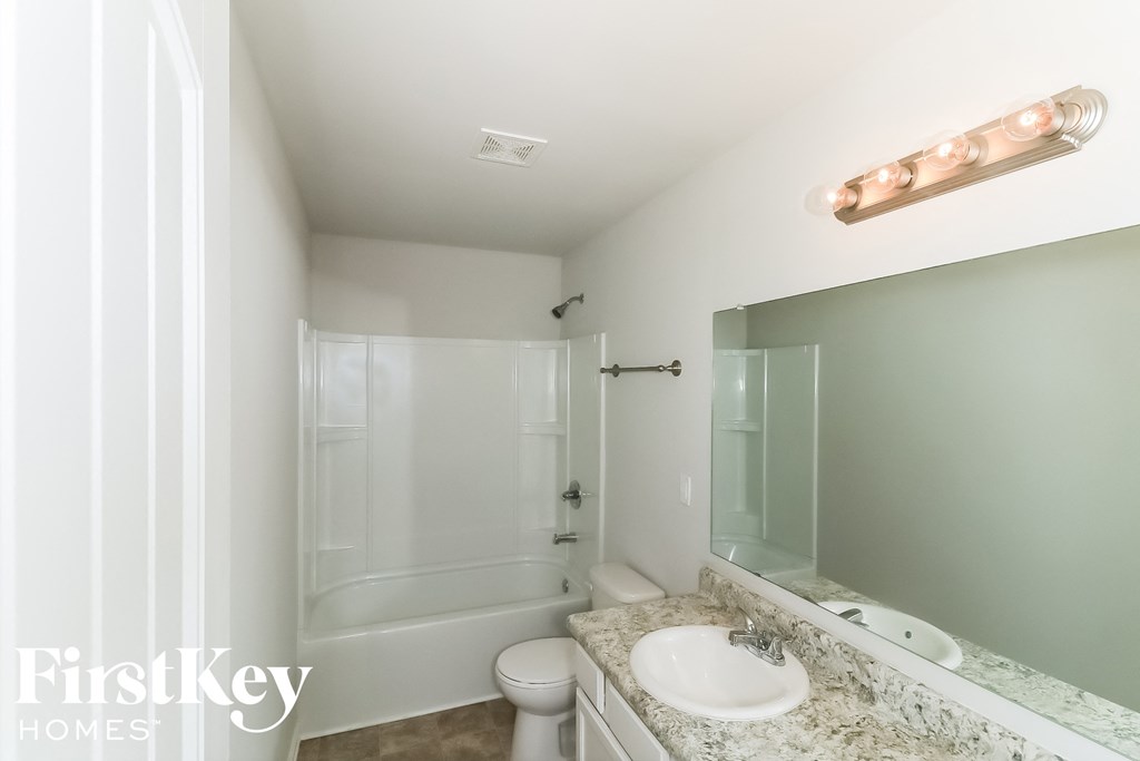 a bathroom with a sink and a toilet and a shower