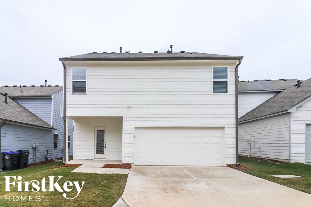 a white house with a driveway in front of it