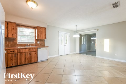 A kitchen with wooden cabinets and a washing machine.