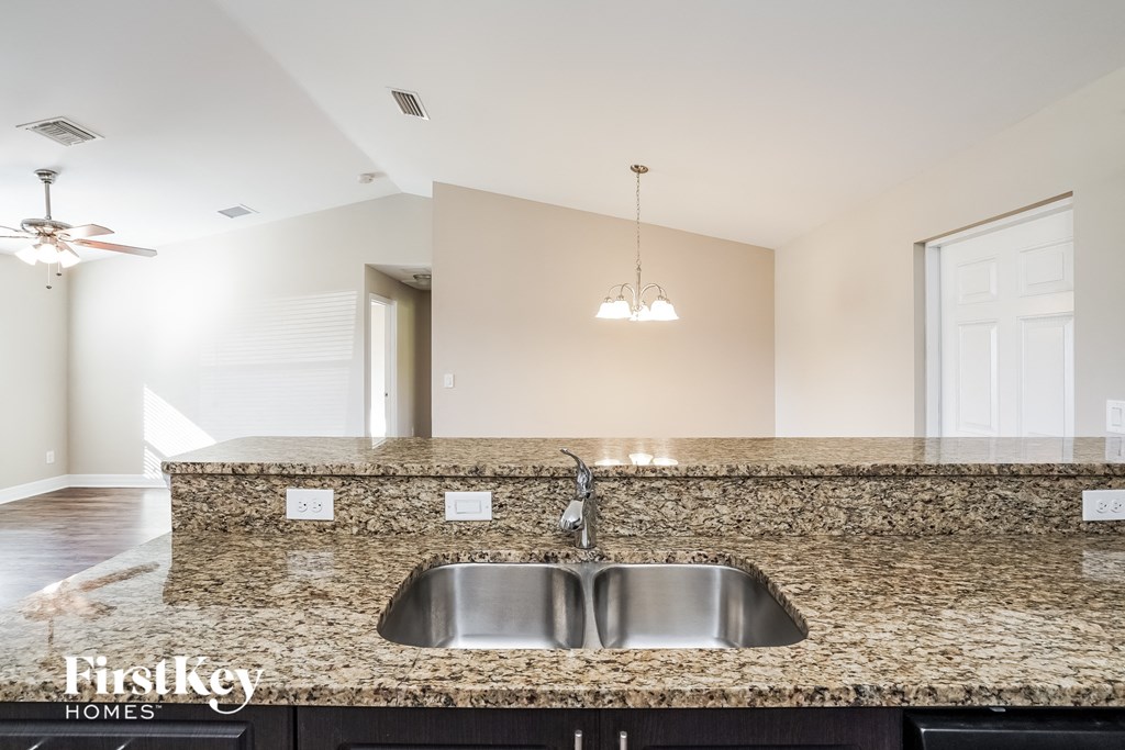 a kitchen with granite counter tops and a sink