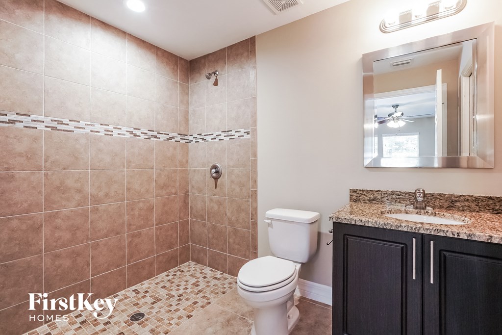 a bathroom with a toilet and a sink and a mirror