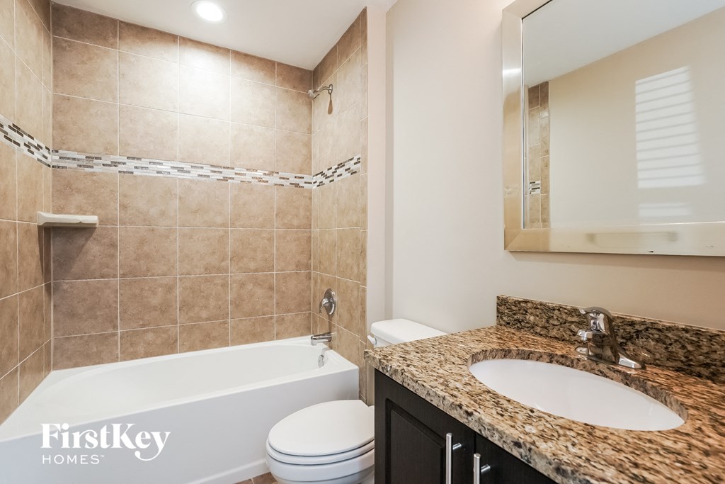 a bathroom with a tub and a sink and a toilet