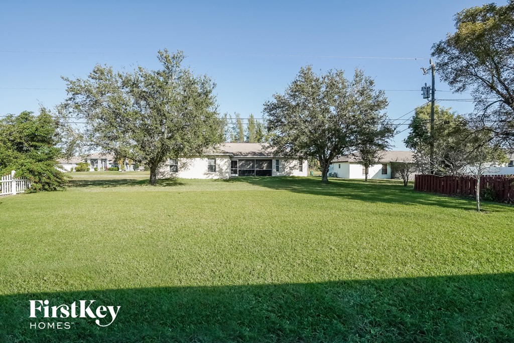 a large yard with a house in the background