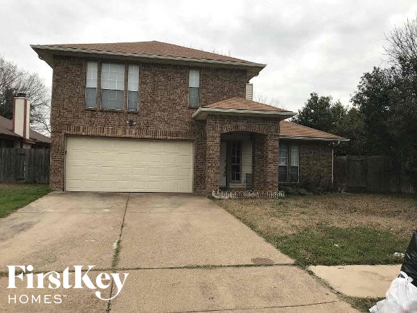 a brick house with a white garage door