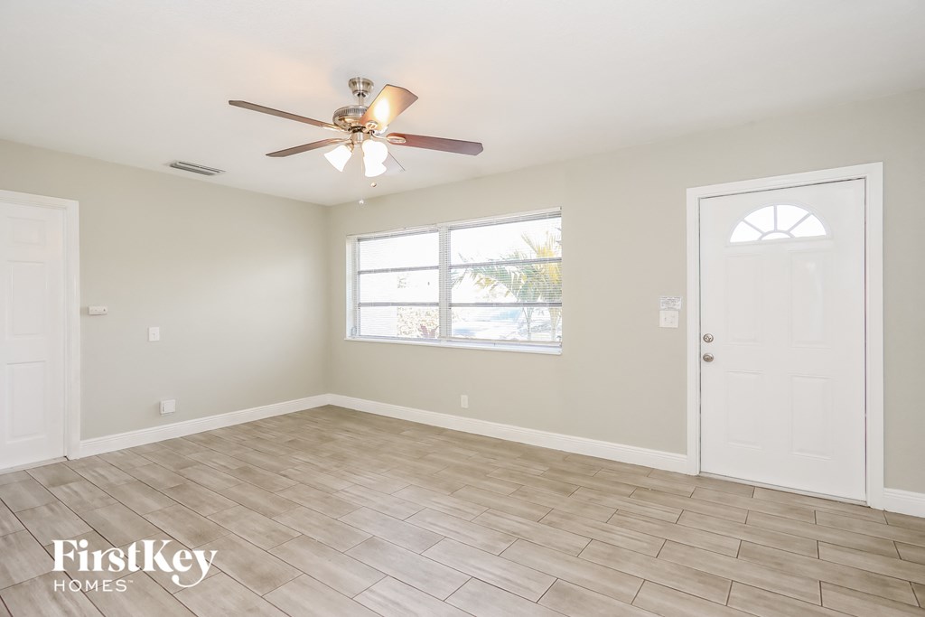 a living room with a ceiling fan and a window