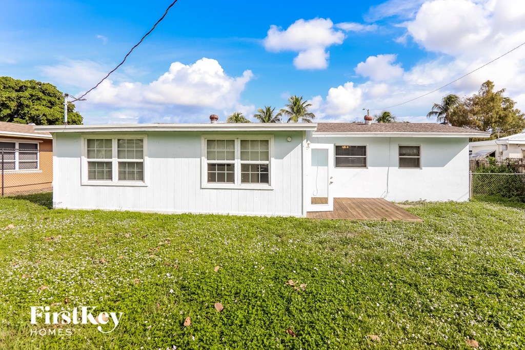 a white house with green grass and a yard