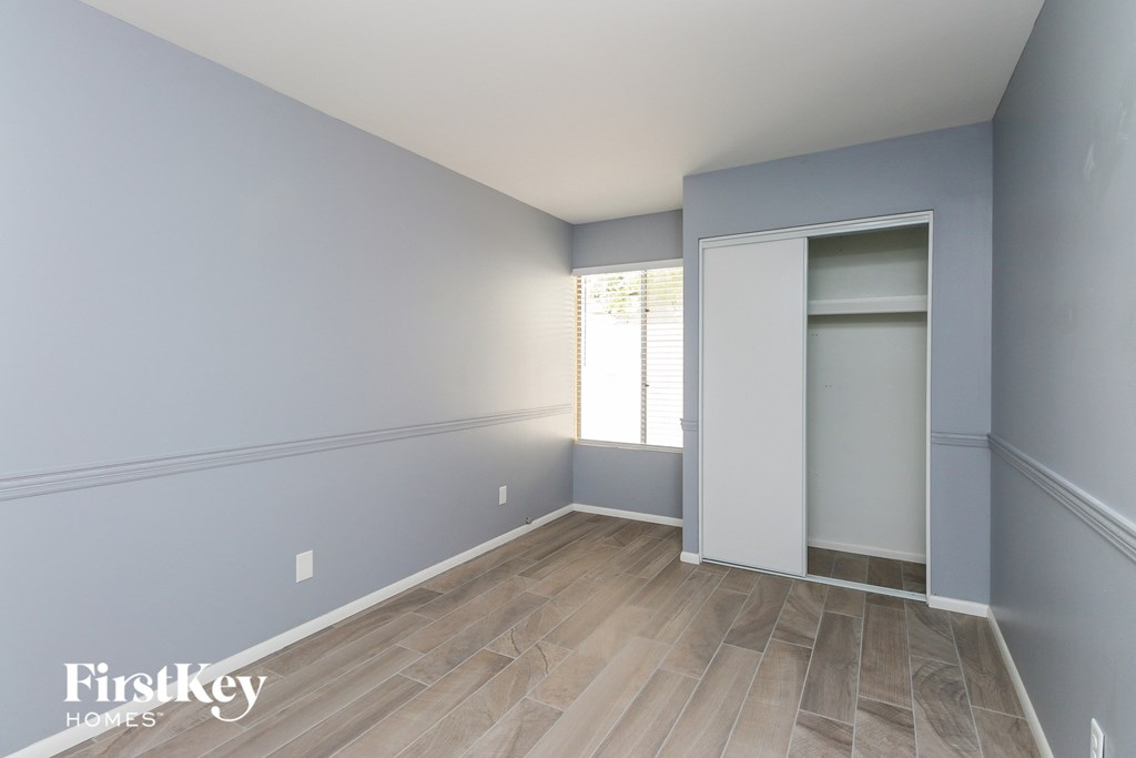 a room with blue walls and wood flooring and a closet