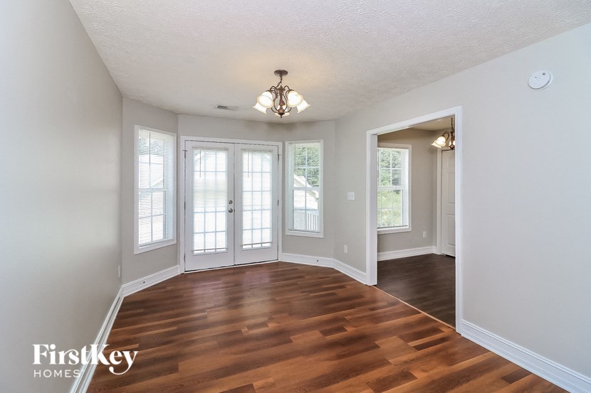A room with a wooden floor and a chandelier.
