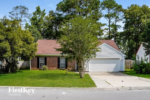 a small brick house with a white garage door