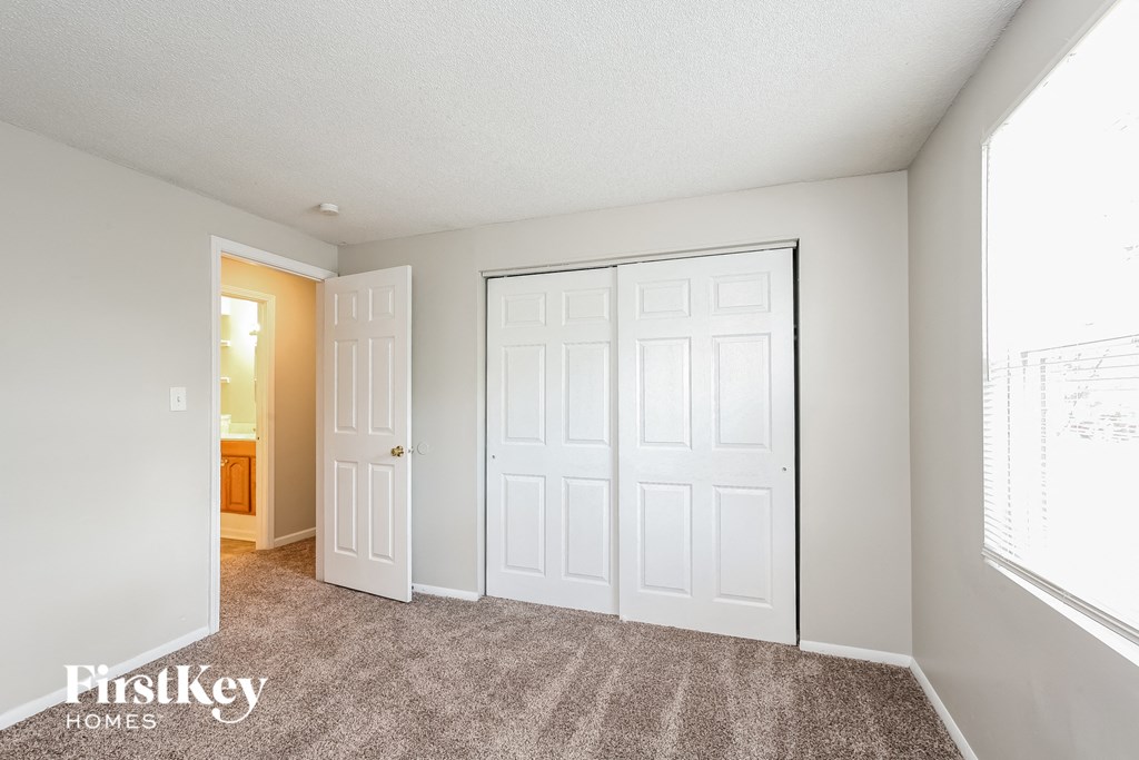a bedroom with two closets and a door to a bathroom