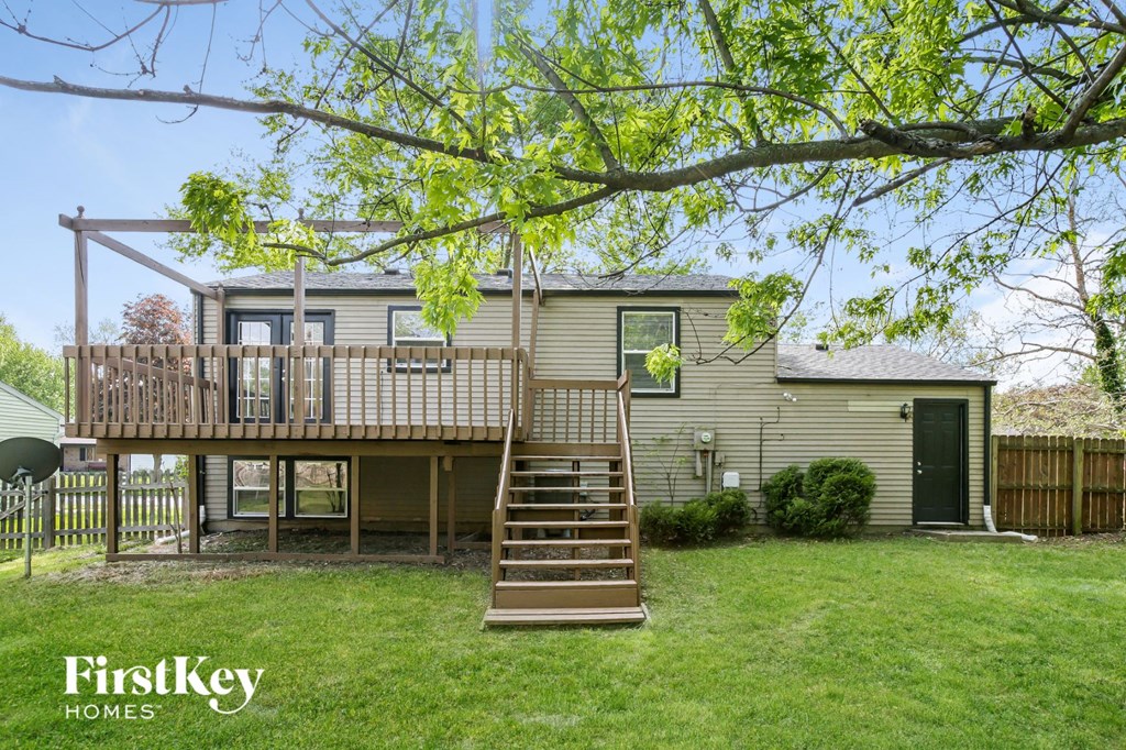 a home with a deck on top of a house