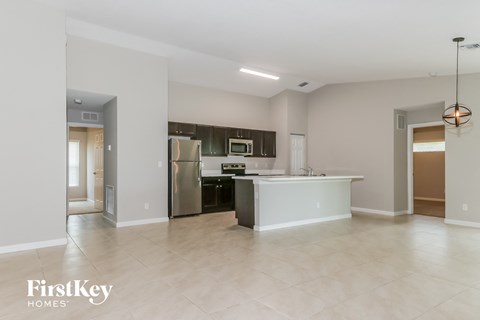 a large kitchen with stainless steel appliances and tile flooring