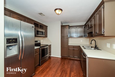 a kitchen with stainless steel appliances and a white counter top