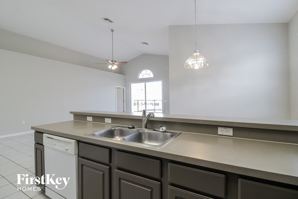 an empty kitchen with a sink and a window
