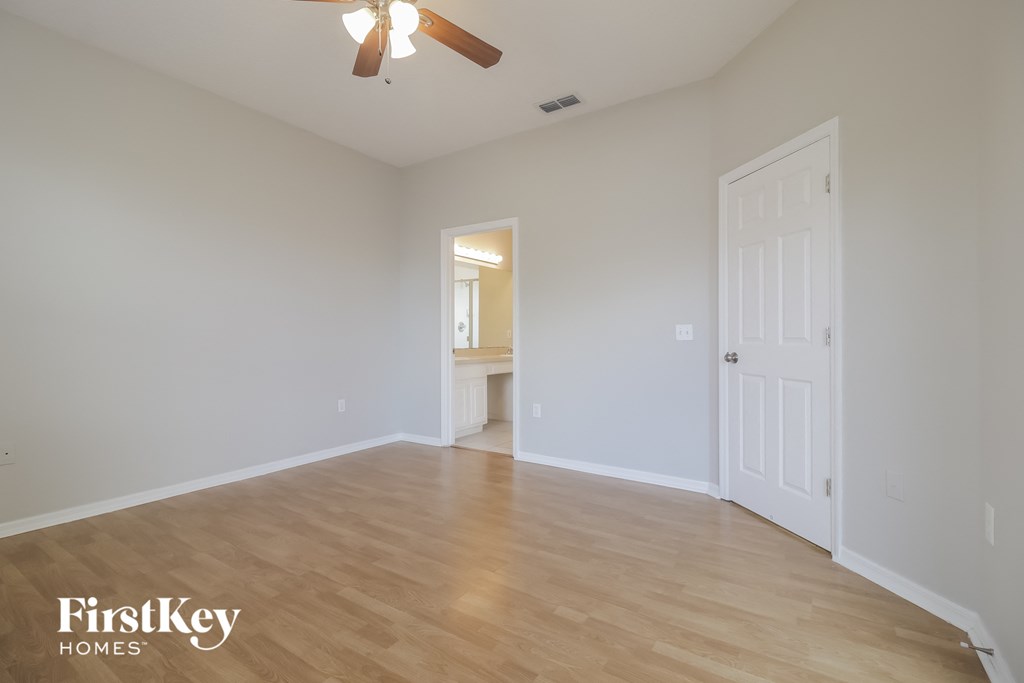 a living room with a hard wood floor and a white door
