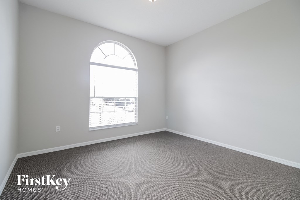 an empty living room with a large window
