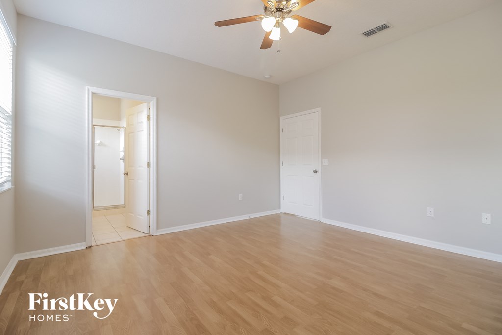 a living room with a wood floor and a ceiling fan