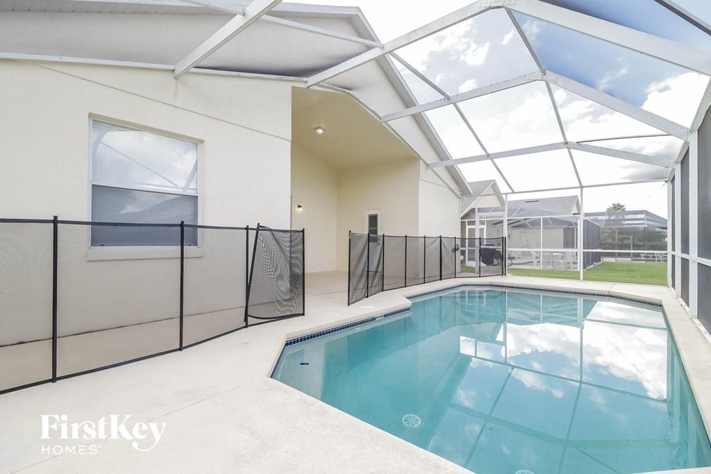a swimming pool in a large room with glass ceilings