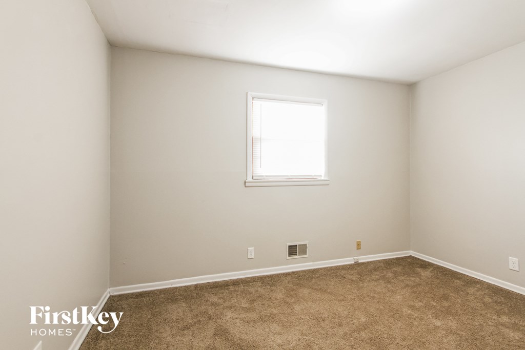 a room with carpet and a window in it