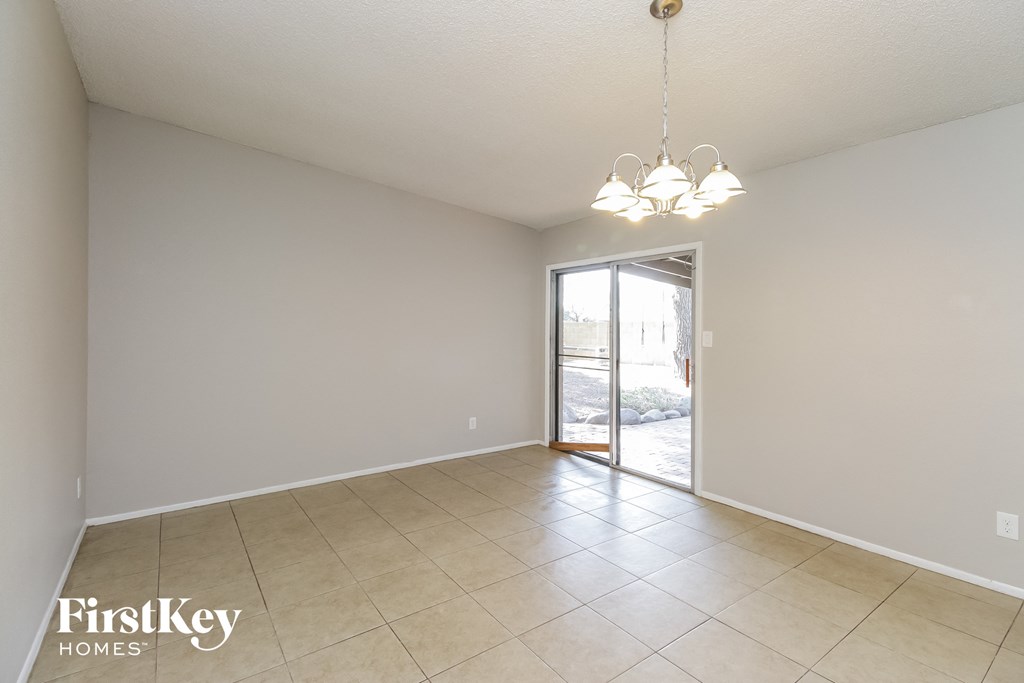 an empty living room with a sliding glass door to a patio