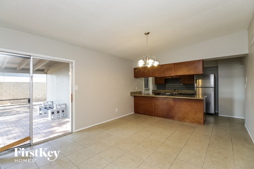 an empty kitchen with a sliding glass door to the patio