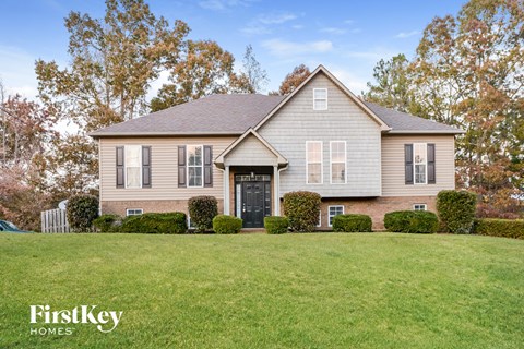 a home with a large lawn in front of it