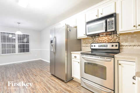 a kitchen with stainless steel appliances and white cabinets