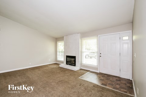 a living room with a fireplace and a white door