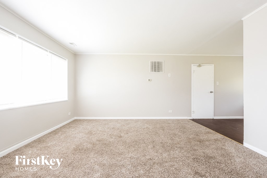 a white room with a carpet and a white door