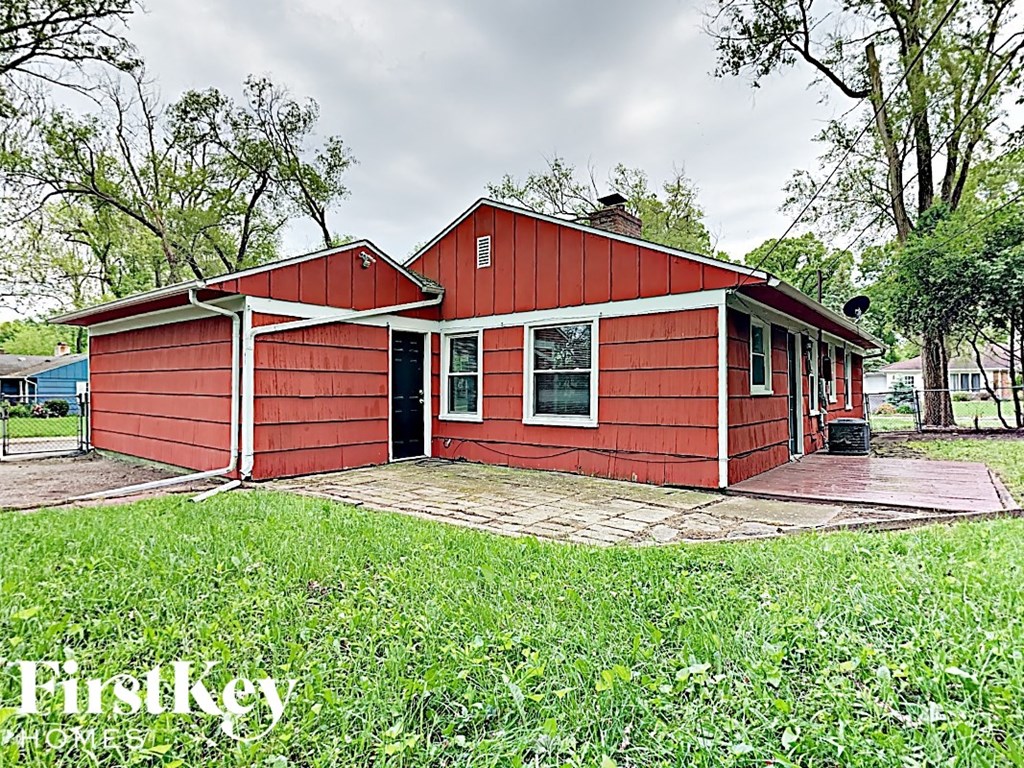 a red house with a porch and a yard