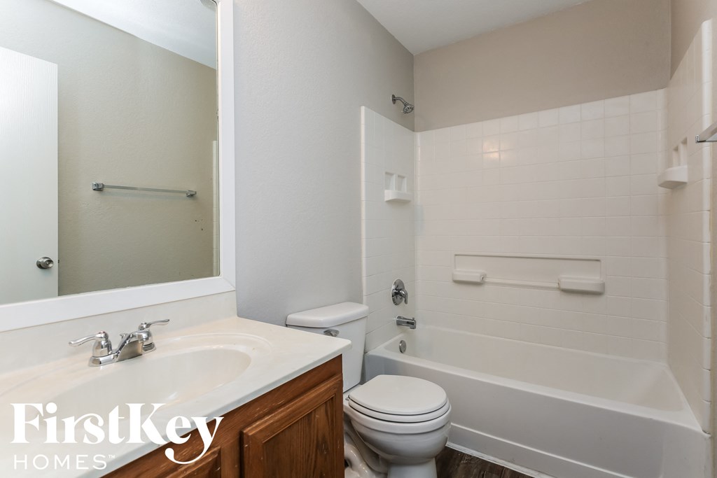 a bathroom with a toilet and a sink and a tub