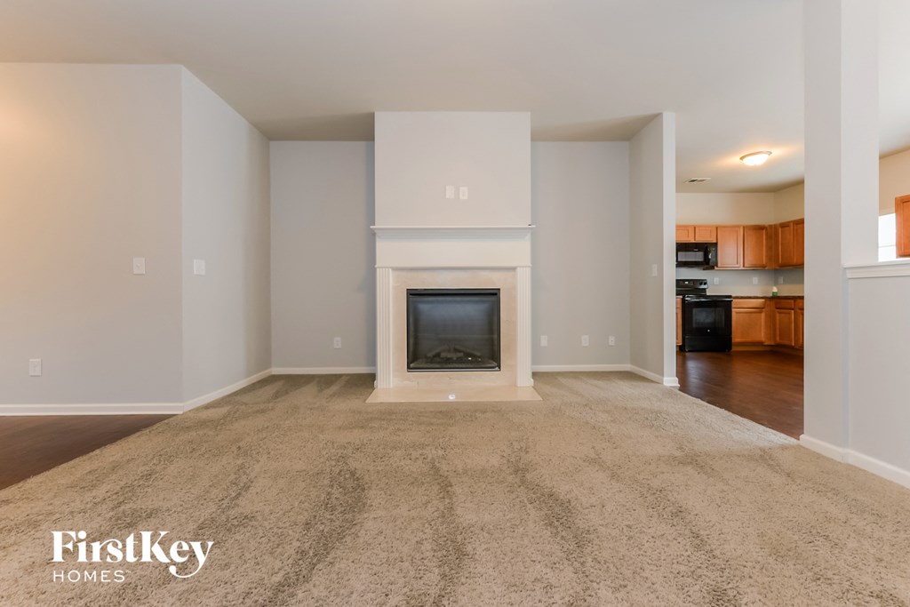 A spacious living room with a fireplace and a television.