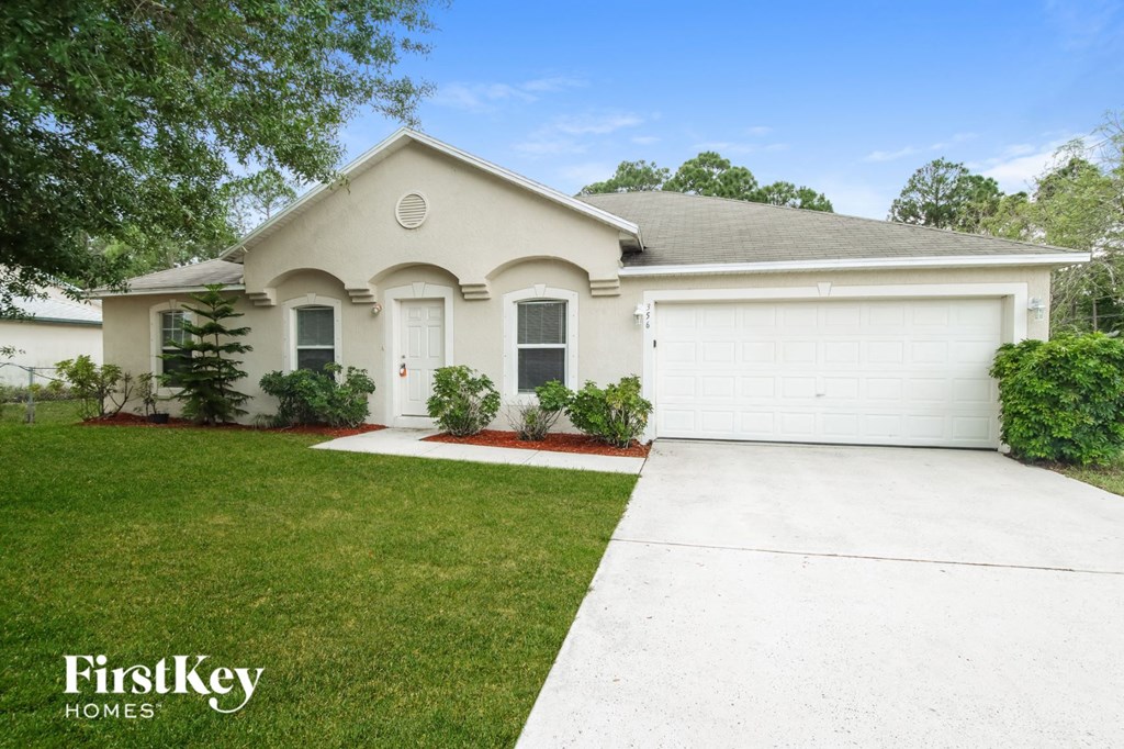 A white house with a garage is for sale by FirstKey Homes.