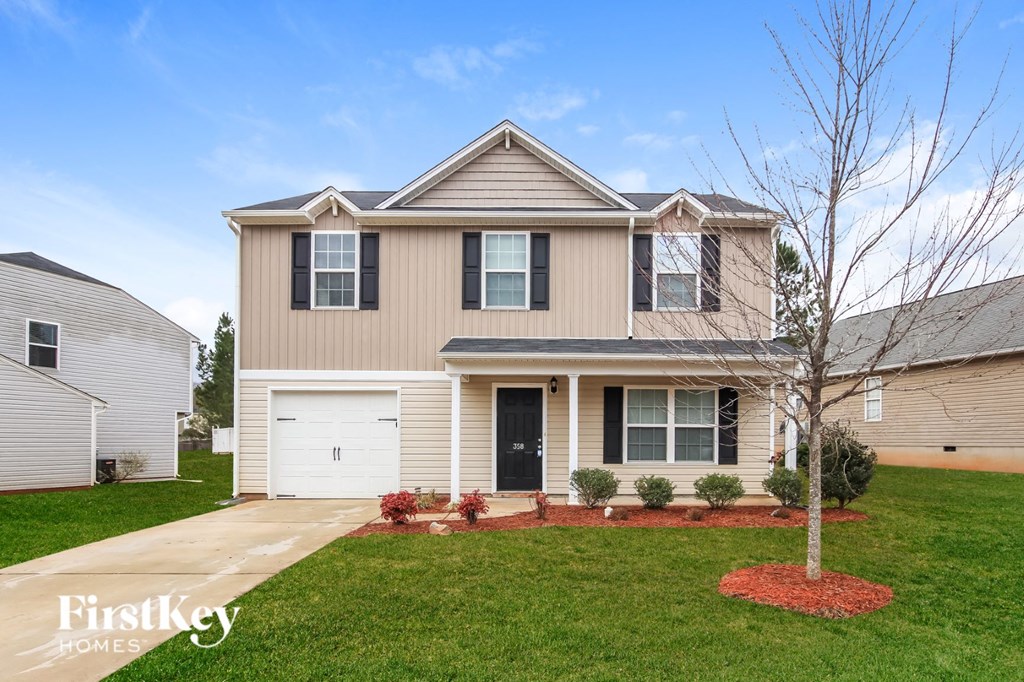 a beige house with a white garage door