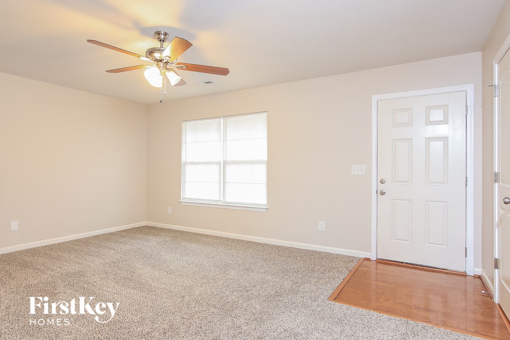 a bedroom with a ceiling fan and a white door